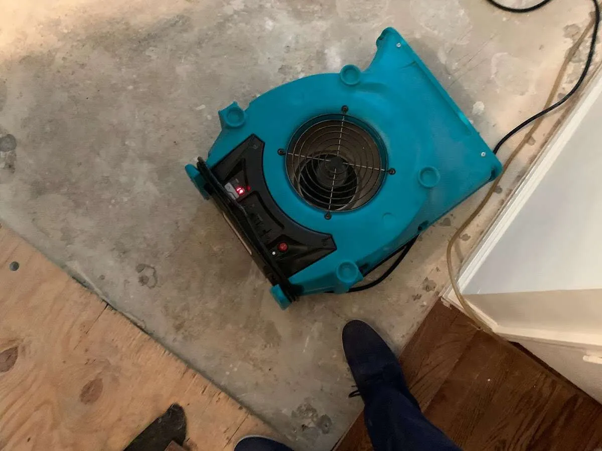 Air mover drying subfloor during Commercial Water Damage Restoration in East Foothills